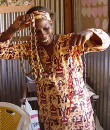 Waithera displaying wonderful necklaces of Heidi beads--made of paper.